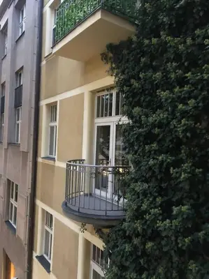 a building with a balcony on the side of it at Exclusive Unique Apartment - Prague Central in Prague