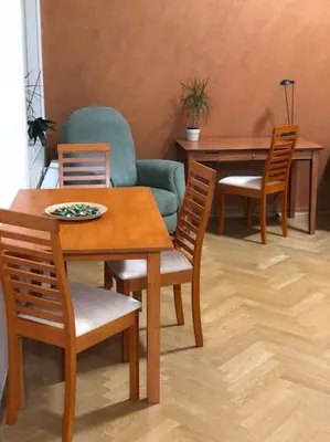 a dining room with a table and four chairs at Exclusive Unique Apartment - Prague Central in Prague