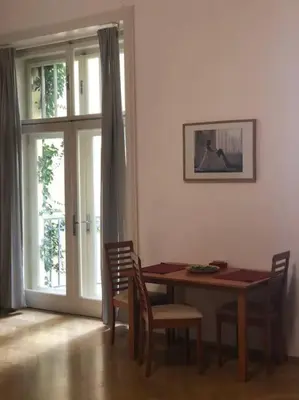 a dining room with a table and chairs and a window at Exclusive Unique Apartment - Prague Central in Prague