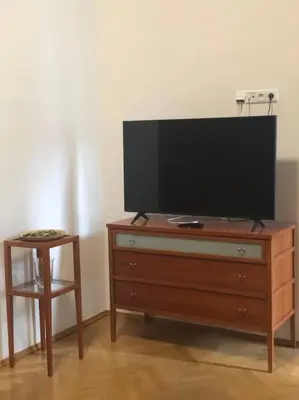 a television on top of a dresser with a stool at Exclusive Unique Apartment - Prague Central in Prague