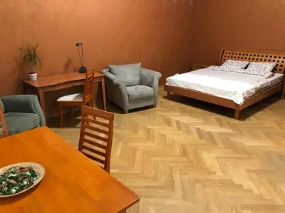 a bedroom with a bed and a table and chairs at Exclusive Unique Apartment - Prague Central in Prague