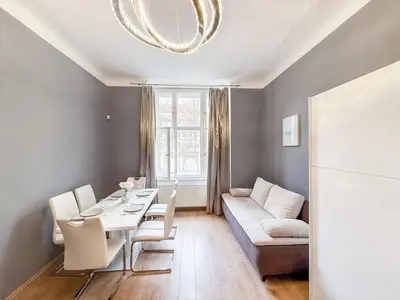 a living room with a table and a couch at Josefov Riverside Apartment in Prague