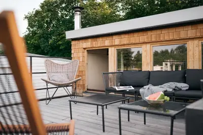 a patio with a couch and chairs on a deck at HOUSEBOAT FRED Prague in Prague