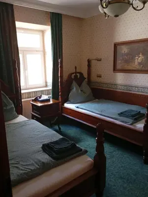 a bedroom with two beds and a window at hotel Memorial in Terezín
