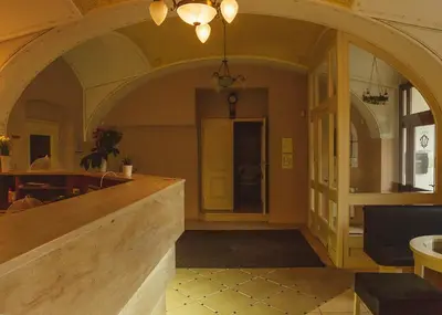 a lobby with an archway and a counter in a building at hotel Memorial in Terezín