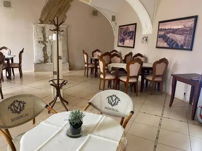 a restaurant with tables and chairs in a room at hotel Memorial in Terezín