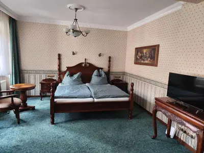 a bedroom with a bed and a piano at hotel Memorial in Terezín