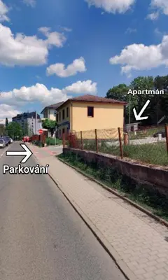 aphalt road with a sign on the side of a street at Apartmán Višňová in Milovice