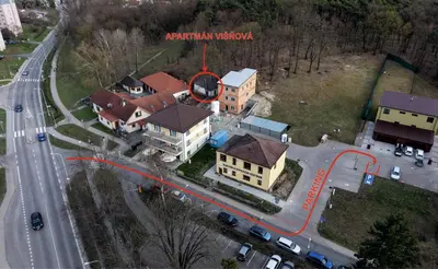 an aerial view of a house on a street with a red arrow at Apartmán Višňová in Milovice