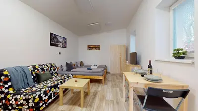 a living room with a couch and a table at Apartmán Višňová in Milovice