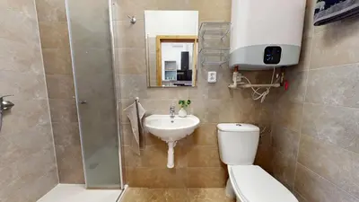 a bathroom with a toilet and a sink and a shower at Apartmán Višňová in Milovice