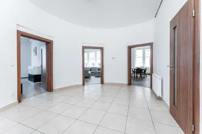 an empty hallway with doors and a living room at Apartmán Riegrovo náměstí in Poděbrady