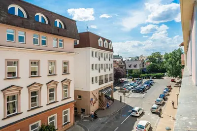 a city street with cars parked in a parking lot at Apartmán Riegrovo náměstí in Poděbrady