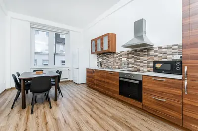 a kitchen with a table and a stove and a microwave at Apartmán Riegrovo náměstí in Poděbrady