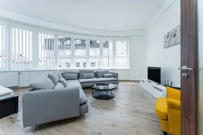 a living room with a couch and a table at Apartmán Riegrovo náměstí in Poděbrady