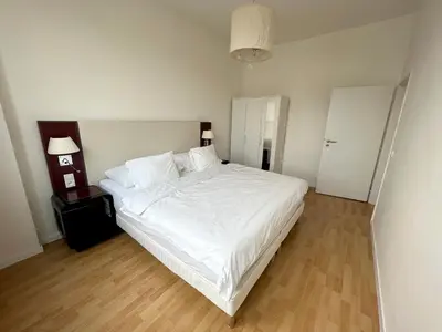 a bedroom with a large bed with white sheets at Holiday home Prague in Prague