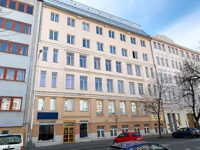 a large building with cars parked in front of it at Holiday home Prague in Prague