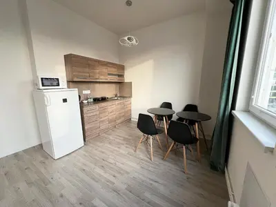 a kitchen with four chairs and a table and a refrigerator at Holiday home Prague in Prague