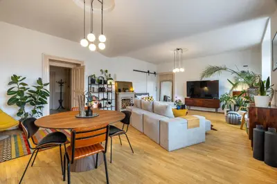 a living room with a table and a couch at Apartment Ruska in Prague