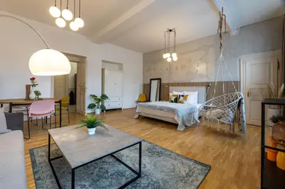 a living room with a bed and a table at Apartment Ruska in Prague