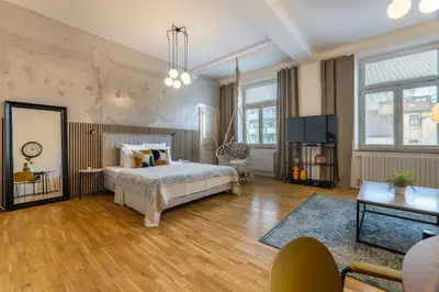 a bedroom with a bed and a television in it at Apartment Ruska in Prague
