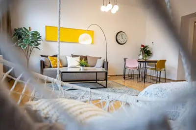 a living room with a couch and a table at Apartment Ruska in Prague