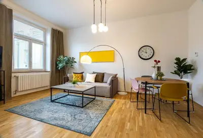 a living room with a couch and a table at Apartment Ruska in Prague