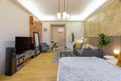 a living room with a couch and a tv at Apartment Ruska in Prague