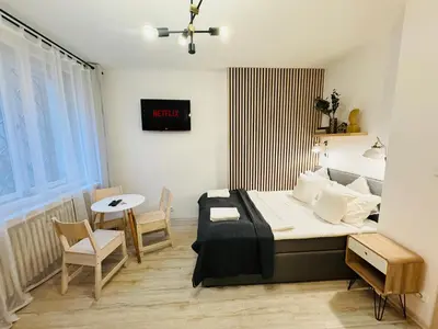 a bedroom with a bed and a table and chairs at NiceLovely & Prague Apartment Dlouha in Prague