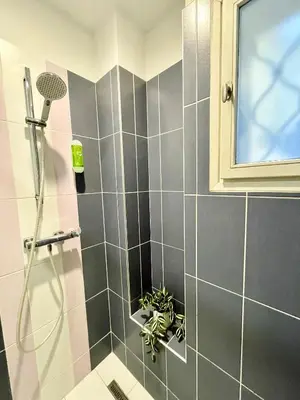 a bathroom with a shower with a drain at NiceLovely & Prague Apartment Dlouha in Prague