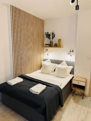 a bedroom with a large bed with two towels on it at NiceLovely & Prague Apartment Dlouha in Prague