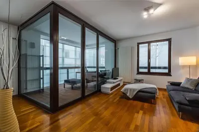 a living room with a couch and a table at Modern spacious flat with a terrace and a parking in Prague