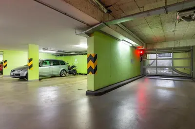an empty parking garage with a car parked in it at Modern spacious flat with a terrace and a parking in Prague