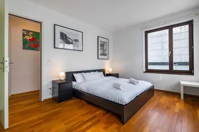 a bedroom with a large bed and a window at Modern spacious flat with a terrace and a parking in Prague