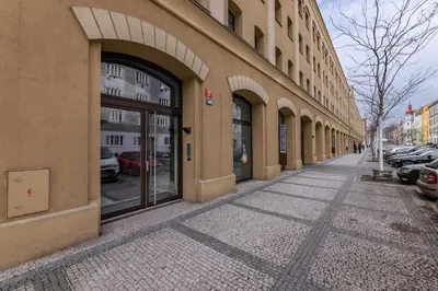 a sidewalk in front of a building with windows at Modern spacious flat with a terrace and a parking in Prague