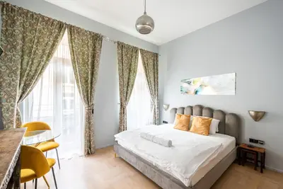 a bedroom with a bed with curtains and a table at Prague Spirit in Prague