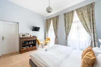 a bedroom with a bed and a tv and a window at Prague Spirit in Prague