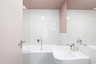 a white bathroom with a sink and a mirror at Prague Spirit in Prague