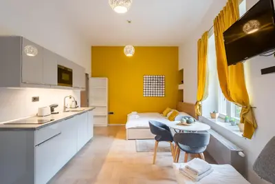 a kitchen and a bedroom with a bed and a table at Prague Spirit in Prague
