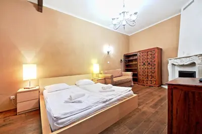 a bedroom with a bed and a couch and a fireplace at Rose Antique Apartment in Prague