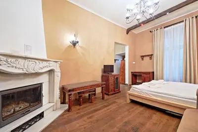 a bedroom with a bed and a fireplace at Rose Antique Apartment in Prague