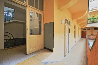 an empty hallway of a building with a door at Rose Antique Apartment in Prague