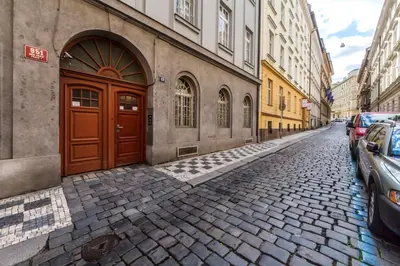 a cobblestone street with a brown door on a building at Rose Antique Apartment in Prague