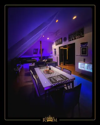 a dining room with a table and purple lighting at RM Luxury Apartment in Prague • 6 People • Free Parking • Pets in Prague
