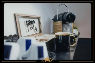 a desk with a cup of coffee and a picture at RM Luxury Apartment in Prague • 6 People • Free Parking • Pets in Prague