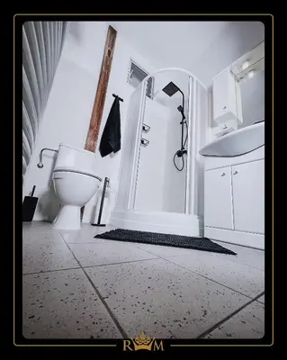 a white bathroom with a toilet and a sink at RM Luxury Apartment in Prague • 6 People • Free Parking • Pets in Prague