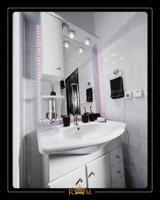 a white bathroom with a sink and a mirror at RM Luxury Apartment in Prague • 6 People • Free Parking • Pets in Prague