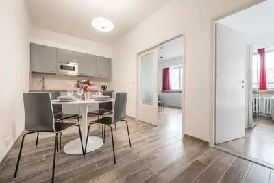 a kitchen and dining room with a table and chairs at Merkur apartments in Prague