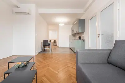 a living room with a couch and a table at Merkur apartments in Prague