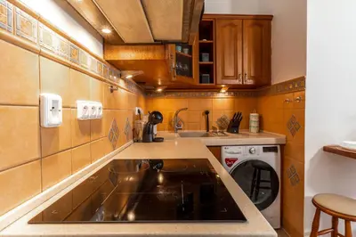 a small kitchen with a sink and a dishwasher at Charming Apartment in Lesser Town in Prague